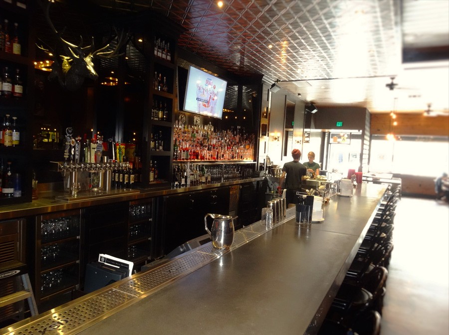 image of bar setting showing counter and liquor display behind